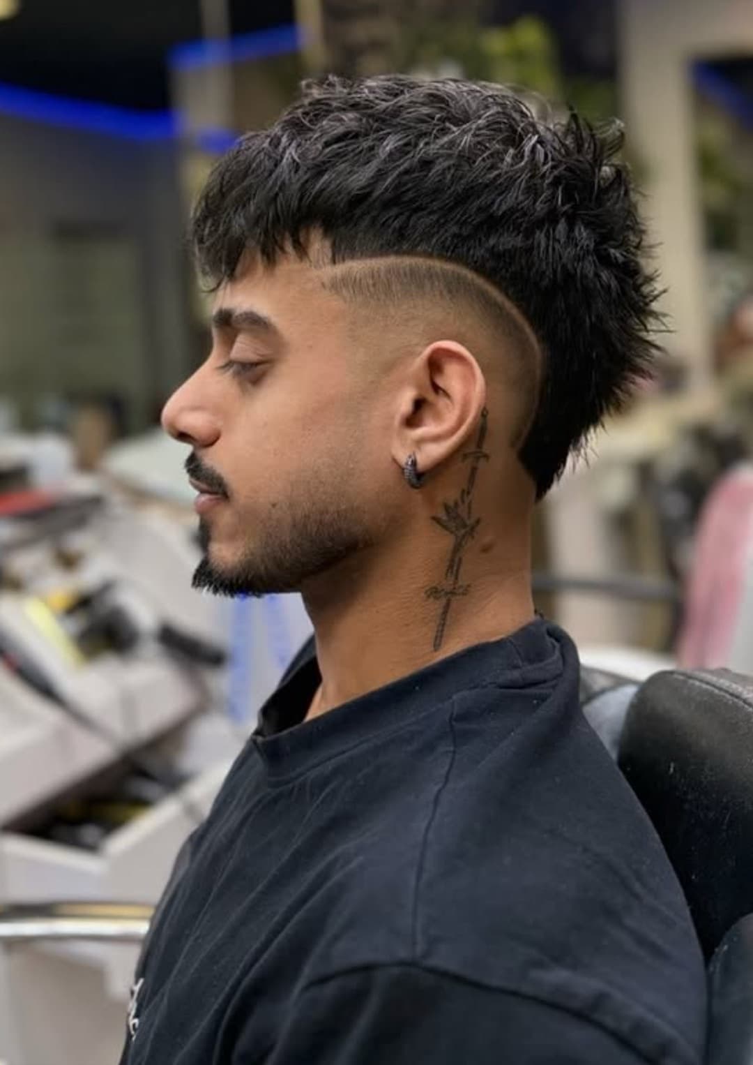 Textured crop with a burst fade and hard part, side profile